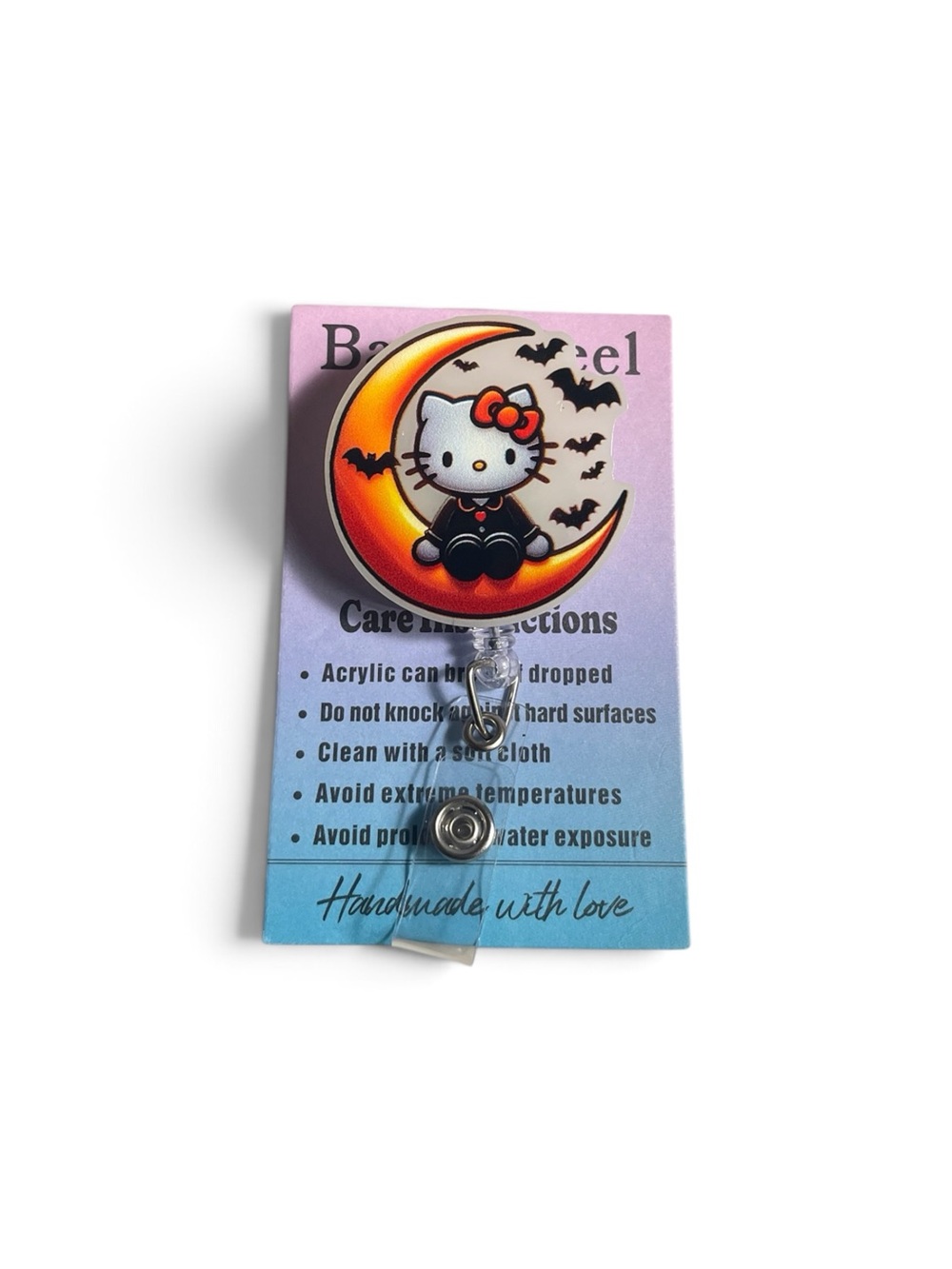 Hello Kitty Glow in the Dark Crescent Moon Badge Reel — Pink and Orange Accent